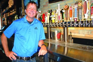 Franchise co-owner John Glockner stands by the tap at the JL Beers restaurant in northeast Minneapolis. Glockner and his partners are opening a second location in Burnsville. (Photo by John Gessner)